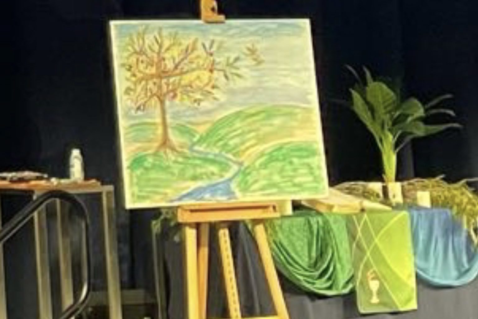 Cross Shaped Tree by living water with birds flying from leafy branches